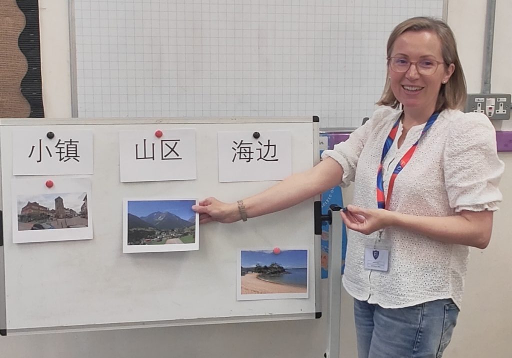 Teacher Heather Salthouse putting images on a whiteboard