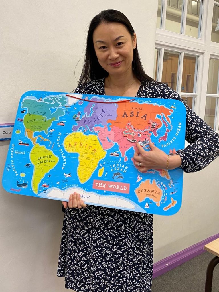 A teacher at Little Mandarin Talkers points to China on a map